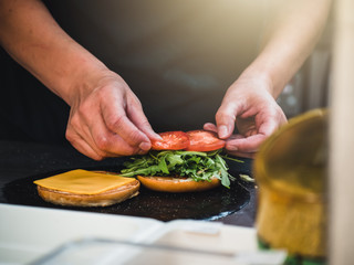 Preparation of burger. Professional chef is preparing burger. Burger making. Cooking hamburger concept.