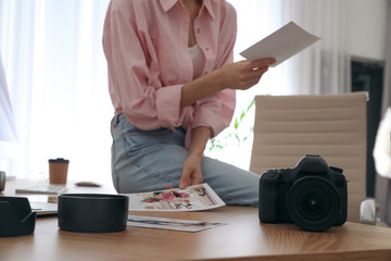 Professional photographer working in light modern office, closeup