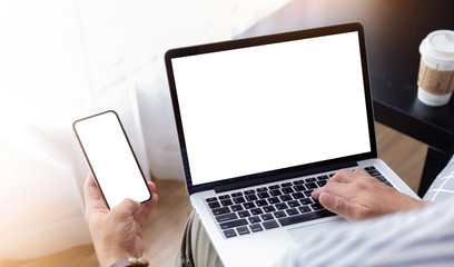 mockup image blank screen computer,cell phone with white background for advertising text,hand man using laptop texting mobile contact business search information on desk in cafe.marketing,design