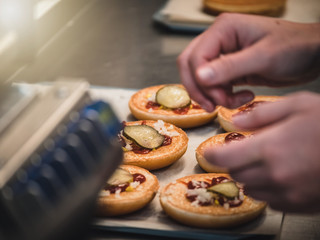 Preparation of burger. Professional chef is preparing burger. Burger making. Cooking hamburger concept.
