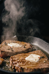 two steaks are fried in a pan. do-it-yourself dinner concept for two. eating at home.