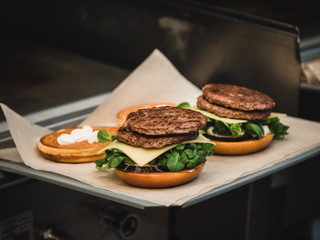 Preparation of burger. Professional chef is preparing burger. Burger making. Cooking hamburger concept.
