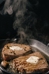 two steaks are fried in a pan. do-it-yourself dinner concept for two. eating at home.