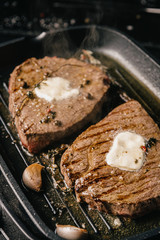 two steaks are fried in a pan. do-it-yourself dinner concept for two. eating at home.