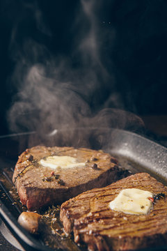 two steaks are fried in a pan. do-it-yourself dinner concept for two. eating at home.