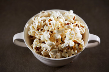 Popcorn in cup on black background 