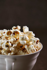 Popcorn in cup on black background 