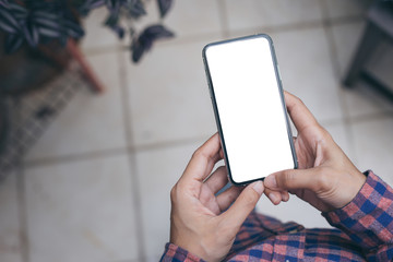 Mockup image blank white screen cell phone.woman hand holding texting using mobile on desk at coffee shop.background empty space for advertise text.people contact marketing business,technology 