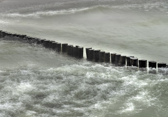 Waves and wooden breakwater