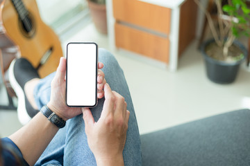 Mockup image blank white screen cell phone.woman hand holding texting using mobile on desk at coffee shop.background empty space for advertise text.people contact marketing business,technology 