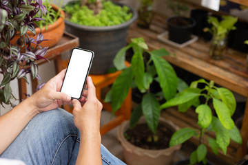 Mockup image blank white screen cell phone.man hand holding texting using mobile on desk at coffee shop.background empty space for advertise text.people contact marketing business,technology 
