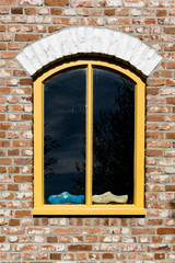 wooden shoes in windows. Concrete wall