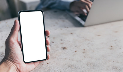 Mockup image blank white screen cell phone.woman hand holding texting using mobile on desk at coffee shop.background empty space for advertise text.people contact marketing business,technology 