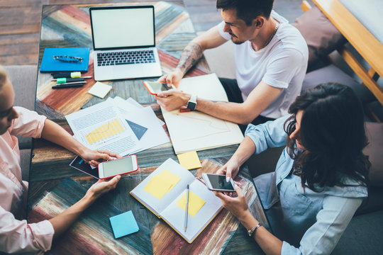 Colleagues planning work on smartphone apps