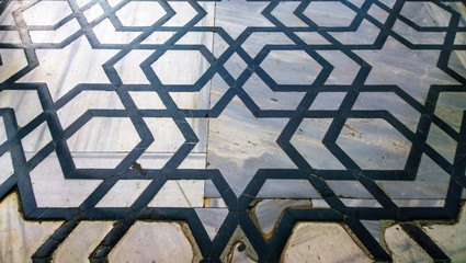 Beautiful geometric shape of lines making a star on the marble tiles as a interesting oriental ornament in the eastern architecture decorations