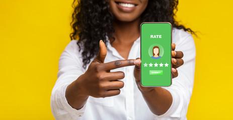 Unrecognizable Black Woman Pointing At Smartphone With Rating Application On Screen