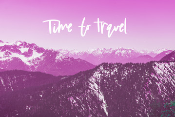 Motivational and inspirational phrase Time to Travel with snowy mountains peaks on the background, toned in purple color