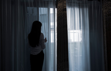 Sad young woman sitting on the bed in the bedroom, People with depression concept.