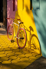 Fototapeta na wymiar Bicycle against a vibrant wall outdoors, Ecological transportation concept..