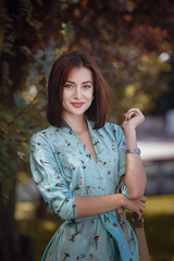 Fashion portrait of young stylish woman walking on the street