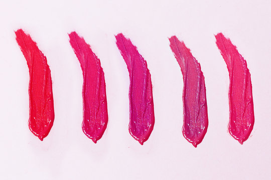 Nail polishes, different shades, lip gloss, pink shades.