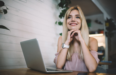 Smiling female blogger thinking on idea for new post