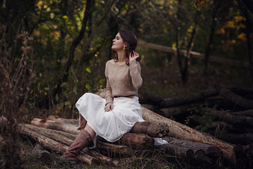 Girl resting in the village, portrait of a woman in rustic style.