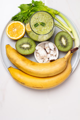 smoothies and ingredients for a smoothie on a plate