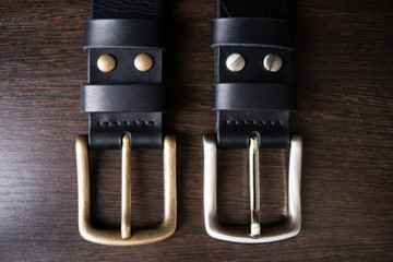 two shiny plaques on a handmade black kazan belt. Shallow depth of field