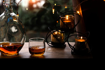 a glass of whiskey on wood bar, soft focus.	