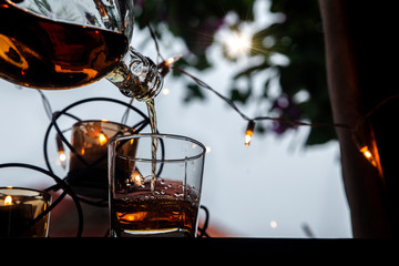a glass of whiskey on wood bar, soft focus.	
