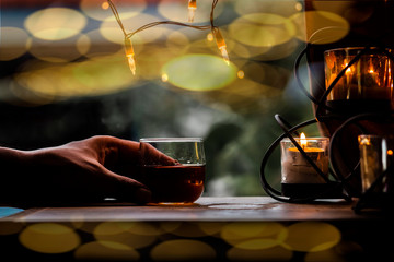 a glass of whiskey on wood bar, soft focus.	