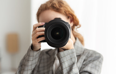 Woman photographer taking photographs on dslr camera