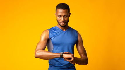 Headshot of afro guy looking at watch - Powered by Adobe