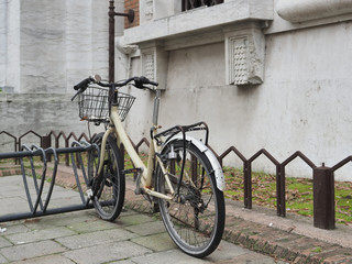Naklejka na ściany i meble Bicycle vandalized next to an old building.