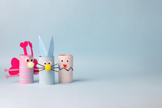 Paper toy Happy Easter home party. Easy crafts for kids on blue background, copy space, die creative idea from toilet tube roll, recycle reuse eco concept, kindergarten daycare