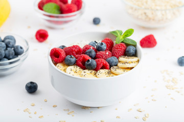 Healthy breakfast with granola, yogurt, berries and bananas. Tasty summer breakfast. 