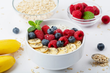 Healthy breakfast with granola, yogurt, berries and bananas. Tasty summer breakfast. 