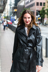 Fototapeta premium Attractive Young Woman in Black Trench Coat