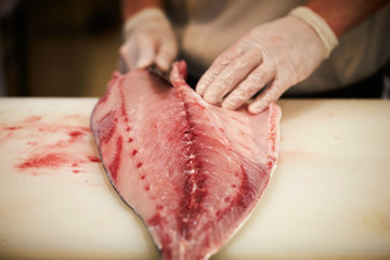 Filleting fish at fish market 