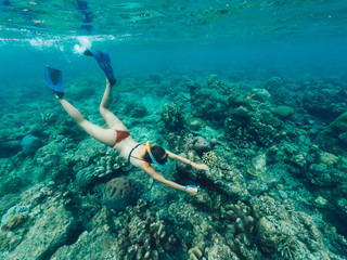 Female extreme swimmer in flippers exploring aquatic oceania depth during getaway adventure on Bali, fit woman wanderer snorkeling in sea during active summer holidays in touristic New Guinea