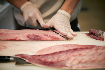 Filleting fish at fish market 