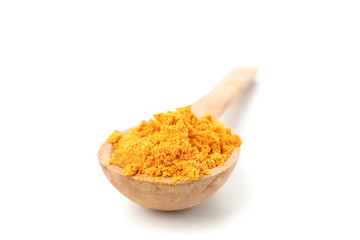 Wooden spoon with turmeric powder isolated on white background, close up