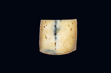 a piece of blue cheese on a black background close-up