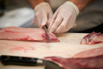 Filleting fish at fish market 