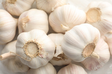 Fresh garlic bulbs textured background, close up