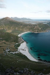 Naklejka premium Hakland beach view from Mannen mountain in Lofoten islands, which is a famous hike. The best view in Lofoten. trekking from the beach to mountain. turquoise sea and sunset.