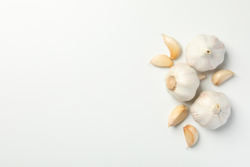 Fresh garlic bulbs, slices on white background, top view. Space for text