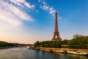 Fototapeta na wymiar Paris Eiffel Tower and river Seine at sunset in Paris, France. Eiffel Tower is one of the most iconic landmarks of Paris. Eiffel tower in summer, Paris, France. The Eiffel Tower in Paris, France.