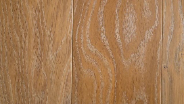 Close-up of wooden floors made of solid planks in light beige tones in a modern interior, interior decoration of the room.